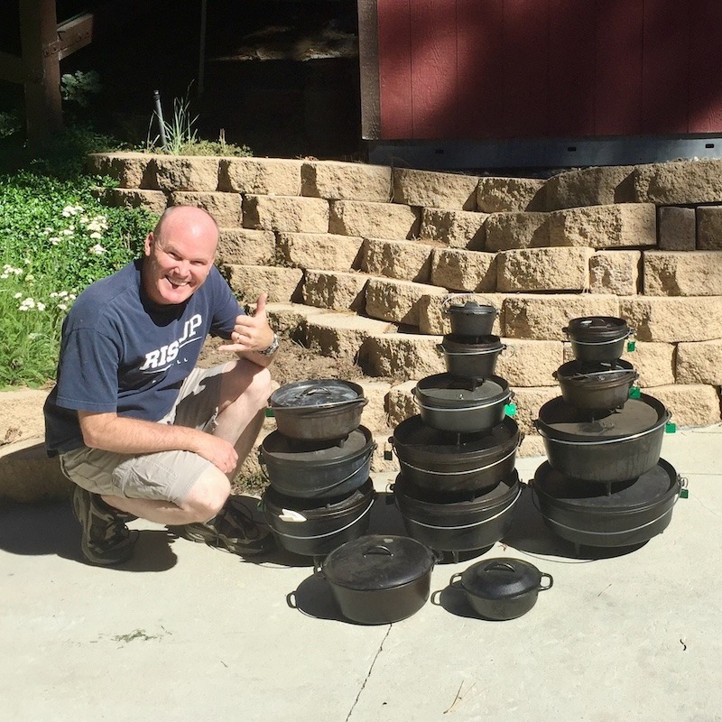 Aaron from Hitched4fun showing a variety of stacked cast iron Dutch oven sizes for camping comparison.