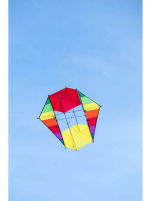 The HQ F-BOX BEACH RAINBOW kite flying gracefully in a wide, clear blue sky.