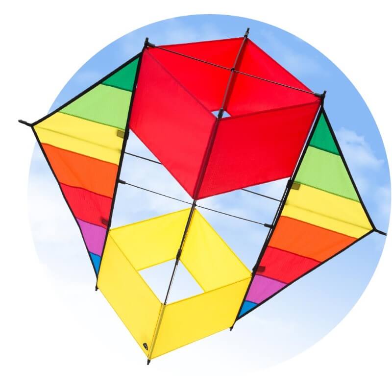 The HQ F-BOX BEACH RAINBOW box kite flying in a blue sky with clouds.