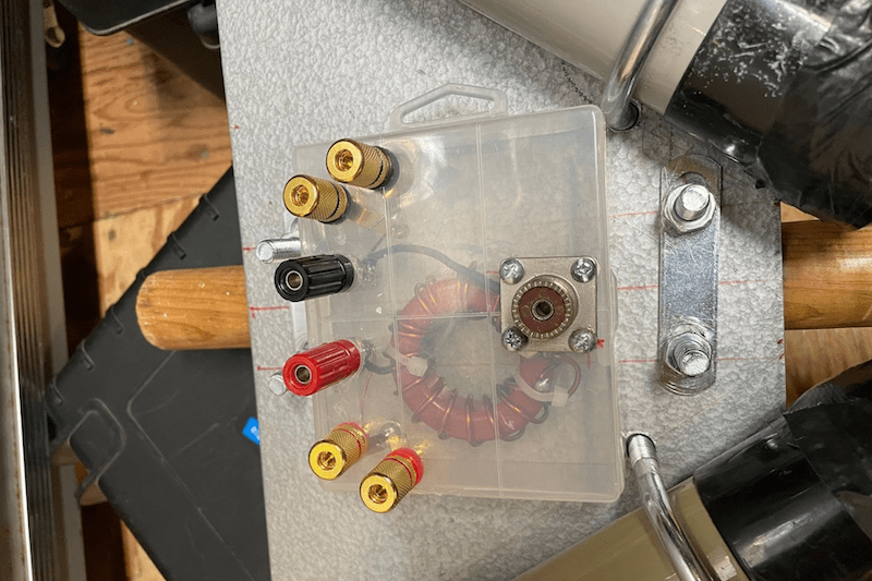 The completed 2:1 balun for the portable delta loop, housed in a clear weatherproof case and mounted to the antenna mast base plate.
