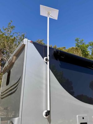 Full view of the RV Flag Pole Buddy Suction Cup Mount 2.0 kit holding a Starlink dish high above a modern silver motorhome, demonstrating a damage-free installation.