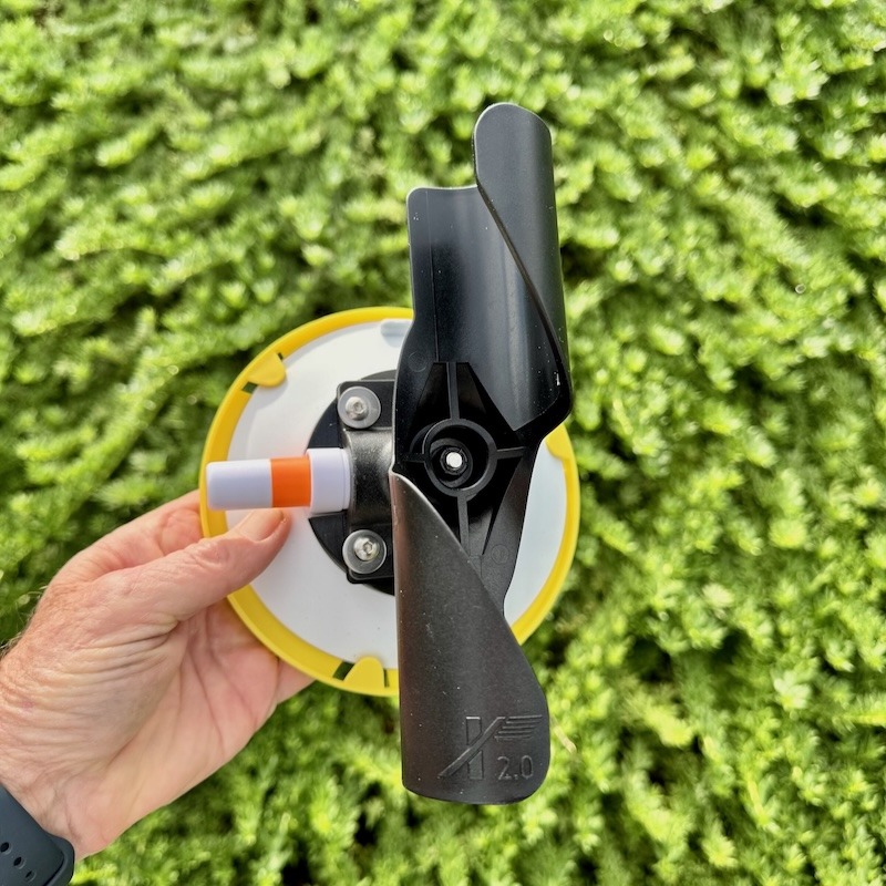 A close-up of the upper "TWIST" mount for the RV Flag Pole Buddy 2.0, showing the vacuum pump plunger and the "2.0" logo on the C-shaped holder.