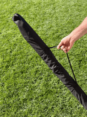 Person carrying the Starlink RV Pole Bag by the shoulder strap across a lawn