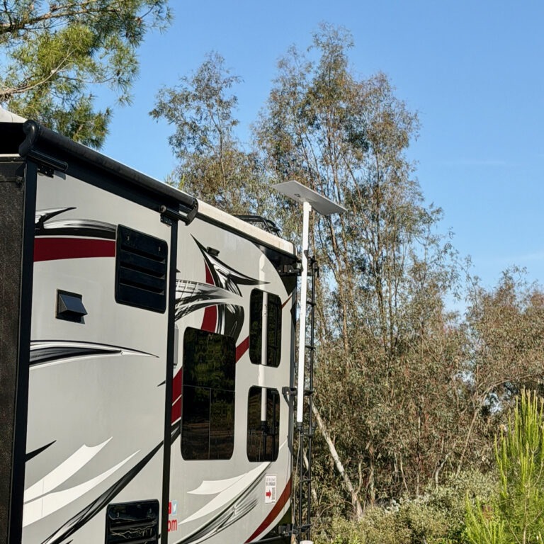 A high-performance Starlink RV setup for resorts featuring a heavy-duty steel pole mount attached to a camper ladder.