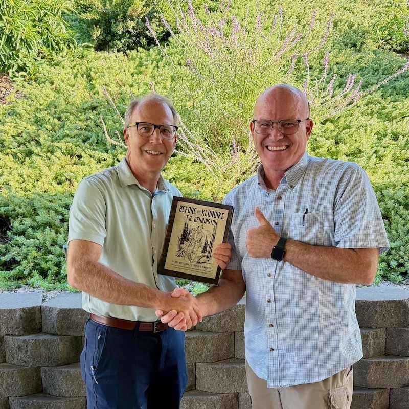 Aaron M. Scullin holding Before the Klondike book with newly discovered cousin Mike S. found through gold rush genealogy research.